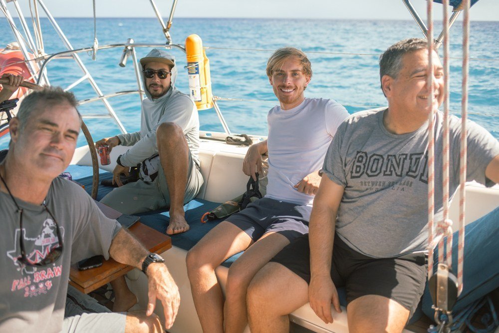 Friends aboard a sailboat