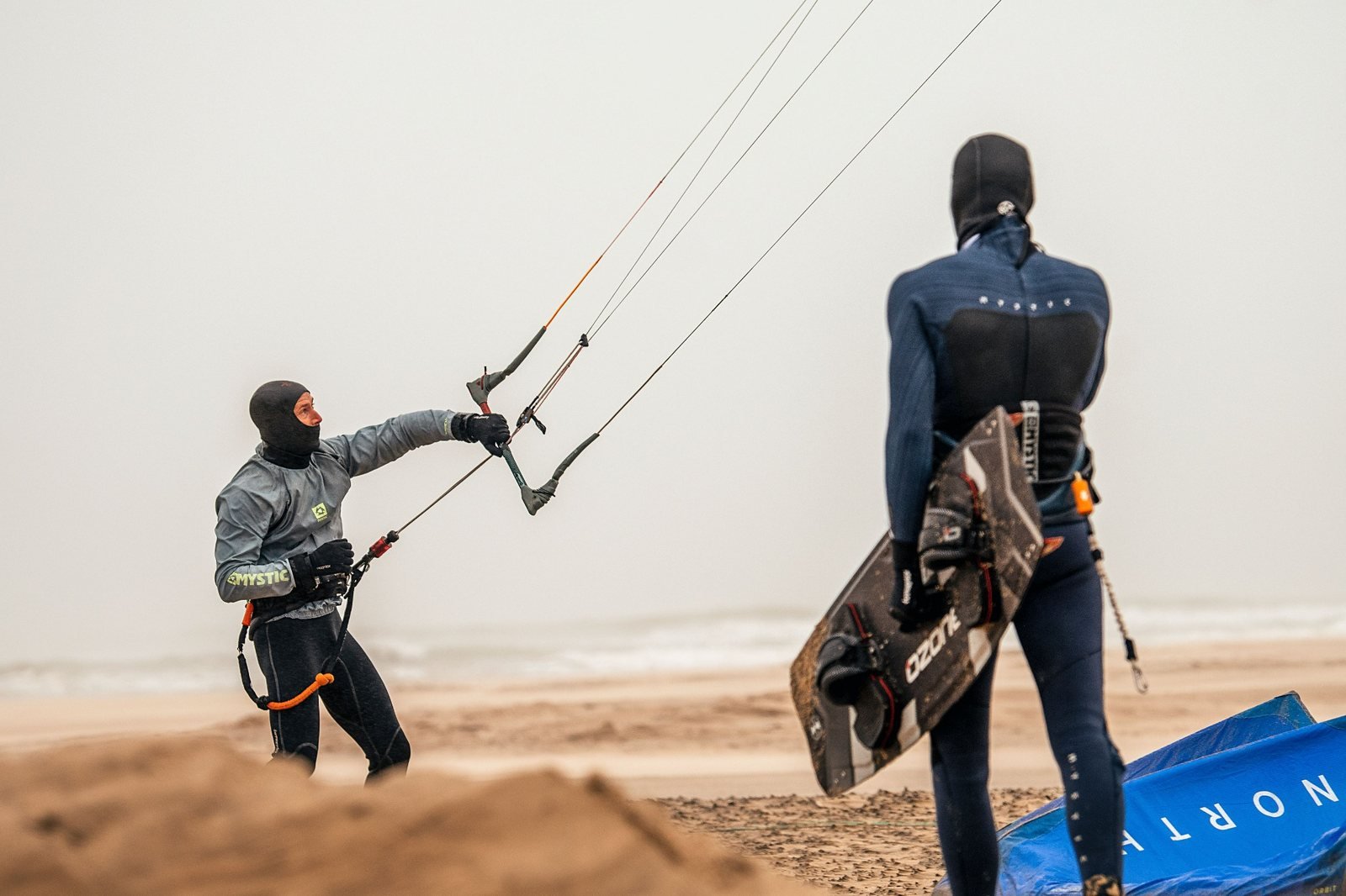 Two kiteboarders preparing for a session at the shoreline